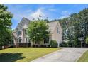 Traditional home with a long driveway, manicured lawn, and mature landscaping adding to its curb appeal at 1035 Eagles Brooke Dr, Locust Grove, GA 30248
