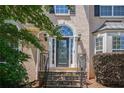 Close-up of the front door with decorative glass and stone steps, showing attention to detail at 1035 Eagles Brooke Dr, Locust Grove, GA 30248