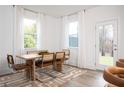 Bright dining room with a modern table and chairs, large windows, and neutral tones at 1722 Gunnin Nw Trce # 233, Atlanta, GA 30318