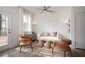 Elegant living room featuring stylish chairs, a sofa, and a modern ceiling fan, with ample natural light at 1722 Gunnin Nw Trce # 233, Atlanta, GA 30318