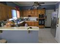 Functional kitchen features stainless steel refrigerator, breakfast bar, and ample cabinetry at 345 Oak Springs Nw Dr, Lawrenceville, GA 30043