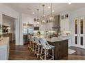 Gourmet kitchen featuring an island, granite counters, stainless steel appliances, and pendant lighting at 50 Canton St # 406, Alpharetta, GA 30009