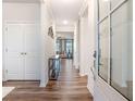 Stylish entryway with dark wood floors, white trim, and a view into the open-concept living area at 112 Leveret Rd, Locust Grove, GA 30248