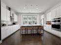Bright kitchen with white cabinets, stainless steel appliances, and a large island with seating at 1127 Provence Ln, Decatur, GA 30033