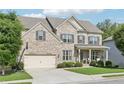 Attractive two-story brick home featuring a basketball hoop on the driveway and a well-maintained lawn at 2793 Bloom Cir, Dacula, GA 30019