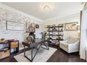 Elegant home office featuring a whitewashed brick accent wall, hardwood floors, and stylish furnishings at 2793 Bloom Cir, Dacula, GA 30019
