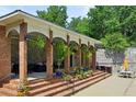Poolside pavilion with brick columns, comfortable seating, and lush greenery for relaxation and entertaining at 4620 Wieuca Ne Rd # 42, Atlanta, GA 30342