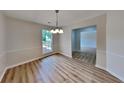 Bright dining room with new flooring, updated lighting, and ample natural light at 1229 Huntington Place Cir, Lithonia, GA 30058