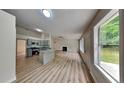 Open living space offering new floors, modern kitchen, and fireplace at 1229 Huntington Place Cir, Lithonia, GA 30058