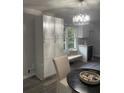 Bright kitchen nook with custom white cabinets, bench seating and decorative lighting at 2135 Niskey Lake Sw Rd, Atlanta, GA 30331