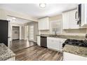 Modern kitchen featuring granite countertops, stainless steel appliances, and updated cabinets at 3436 Dodson Ter, Atlanta, GA 30344