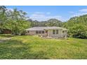 The back of this ranch home features a grassy lawn and a covered patio at 3436 Dodson Ter, Atlanta, GA 30344