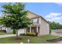 Charming two-story home with a well-manicured front yard and a two-car garage at 345 Lara Ln, Mcdonough, GA 30253