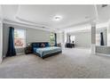 Spacious bedroom suite with a tray ceiling, sitting area, and plenty of natural light from large windows at 4850 Wilshire Xing, Cumming, GA 30040