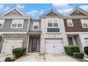 Charming townhome with brick and siding, featuring a one-car garage and a red front door at 5009 Longview Walk, Decatur, GA 30035