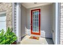 Inviting front door with glass panel, painted a bright red, and sidelights plus house number at 5009 Longview Walk, Decatur, GA 30035