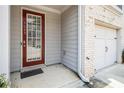 Welcoming front door adjacent to a one-car garage of the townhome at 5009 Longview Walk, Decatur, GA 30035