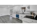 Bright kitchen features white cabinets, stainless steel appliances, granite countertops, and modern flooring at 5774 Forest Dr, Acworth, GA 30102