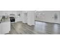 Open concept kitchen showcases granite countertops, modern appliances, and seamlessly connects to the living area at 5774 Forest Dr, Acworth, GA 30102