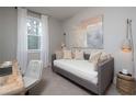 Neutral bedroom showcasing a daybed, decorative wall art, desk, and a window with natural light at 1714 Gunnin Nw Trce # 237, Atlanta, GA 30318