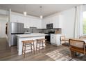 Bright eat-in kitchen with stainless steel appliances, white cabinets, countertops, and a stylish island at 1714 Gunnin Nw Trce # 237, Atlanta, GA 30318