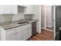 Well-equipped kitchen showcasing granite countertops, stainless steel appliances, and wood flooring at 9188 Jefferson Village Sw Dr, Covington, GA 30014
