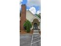 Community clubhouse features a brick chimney and covered entryway at 1231 Creek Forest Ln, Austell, GA 30106