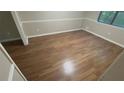Bright bedroom featuring hardwood floors, neutral walls, and a window providing natural light at 145 Huntcliff Ct, Fayetteville, GA 30214