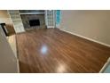 Spacious living room featuring hardwood floors, fireplace with stone surround, and access to the backyard at 145 Huntcliff Ct, Fayetteville, GA 30214