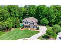 Beautiful home with a lush lawn, mature trees, and a refreshing pool providing a private oasis at 255 Ashmere Ct, Tyrone, GA 30290