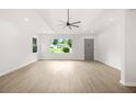 Open-concept living area with new floors, recessed lighting, and a view to the exterior at 1712 Venetian Sw Dr, Atlanta, GA 30311