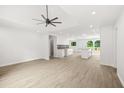 Open-concept living area with recessed lights, ceiling fan and an adjacent kitchen with granite countertops at 1712 Venetian Sw Dr, Atlanta, GA 30311