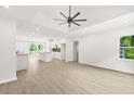 Bright, open-concept living area with new floors, recessed lighting, and a modern ceiling fan at 1712 Venetian Sw Dr, Atlanta, GA 30311