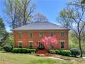 Charming brick home with a well-manicured lawn and a beautiful flowering tree in the front yard at 2270 Emerald Dr, Jonesboro, GA 30236