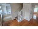 Inviting foyer with hardwood floors and a staircase leading to the upper level of the home at 639 Royal Abbey Dr, Stone Mountain, GA 30088