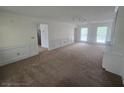 Bright living room with carpet flooring, and fresh, neutral paint at 639 Royal Abbey Dr, Stone Mountain, GA 30088