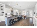 Gourmet kitchen with stainless steel appliances, island seating, modern pendant lights, and hardwood flooring at 217 Napa Dr, Woodstock, GA 30188