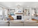 Inviting living room featuring a fireplace, built-in shelving, open to the kitchen at 217 Napa Dr, Woodstock, GA 30188