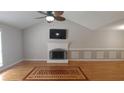 Spacious living room boasts a vaulted ceiling, fireplace, and beautiful hardwood floors at 2477 Briar Valley Way, Dacula, GA 30019