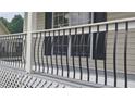 This porch features stylish railings and provides a charming outdoor space for relaxation at 2477 Briar Valley Way, Dacula, GA 30019