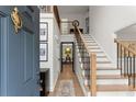 Inviting foyer featuring hardwood floors, a staircase with modern railing, and stylish decor at 4433 Windsor Oaks Cir, Marietta, GA 30066