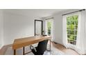 Bright home office featuring a minimalist desk, modern chair, and natural light at 4433 Windsor Oaks Cir, Marietta, GA 30066