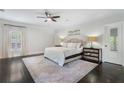 Spacious main bedroom with a neutral color palette, plush rug, and ample natural light at 6805 Bucks Rd, Cumming, GA 30040