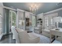 Cozy sitting area with large windows, custom cabinets, a wine fridge, and comfortable seating at 6805 Bucks Rd, Cumming, GA 30040