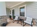 Cozy front porch seating area perfect for relaxing and enjoying the outdoors at 100 Grove View Rd, Woodstock, GA 30189