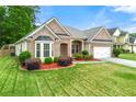 Charming brick home features a manicured lawn, two-car garage, and lovely landscaping at 3700 Long Lake Dr, Douglasville, GA 30135
