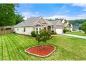 Charming brick home features a manicured lawn, two-car garage, and lovely landscaping at 3700 Long Lake Dr, Douglasville, GA 30135