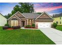 Charming brick home with a manicured lawn, attached garage, and inviting curb appeal at 3700 Long Lake Dr, Douglasville, GA 30135