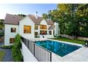 Beautiful backyard featuring a refreshing pool, patio area, and lush landscaping at 490 Mount Paran Rd, Atlanta, GA 30327