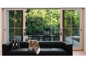 A view of the outdoor dining set, visible through sliding glass doors of the living room at 490 Mount Paran Rd, Atlanta, GA 30327